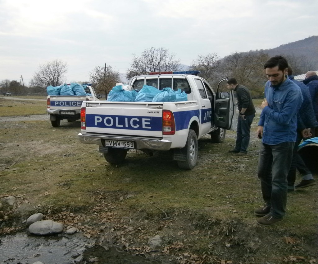 Local police assisting by transporting bags